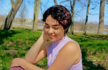 Woman in purple shirt looks off camera