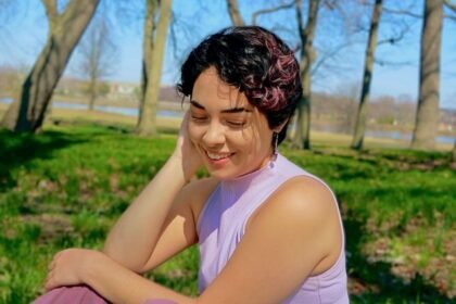 Woman in purple shirt looks off camera