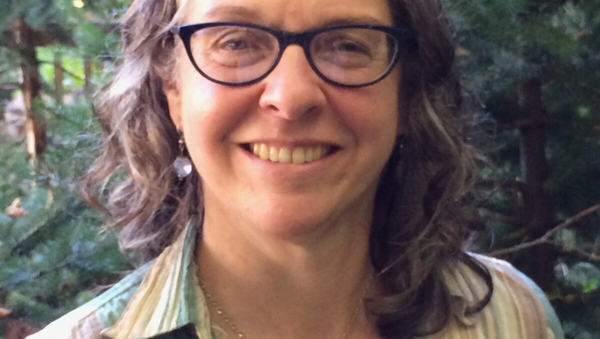 Mandaville formal headshot Woman in striped shirt smiles at camera