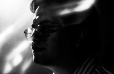 Black and white abstracted photo of a man in profile