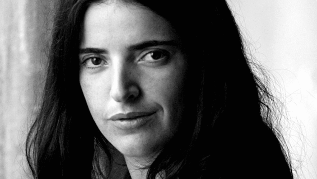 Bejan Matur Black and white photo of a woman with dark hair, looking at the camera.