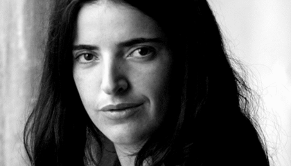 Black and white photo of a woman with dark hair, looking at the camera.