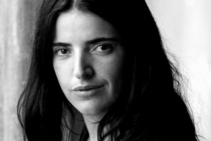 Black and white photo of a woman with dark hair, looking at the camera.